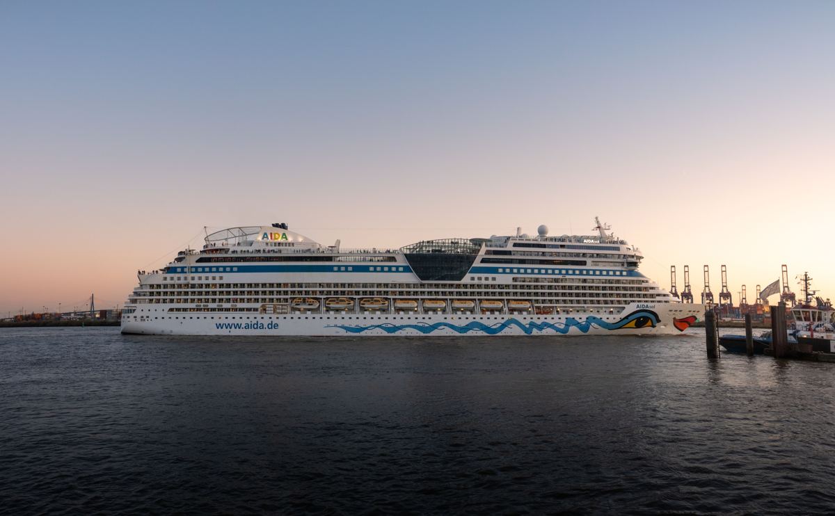 A cruise ship berthed in a harbour at sunset