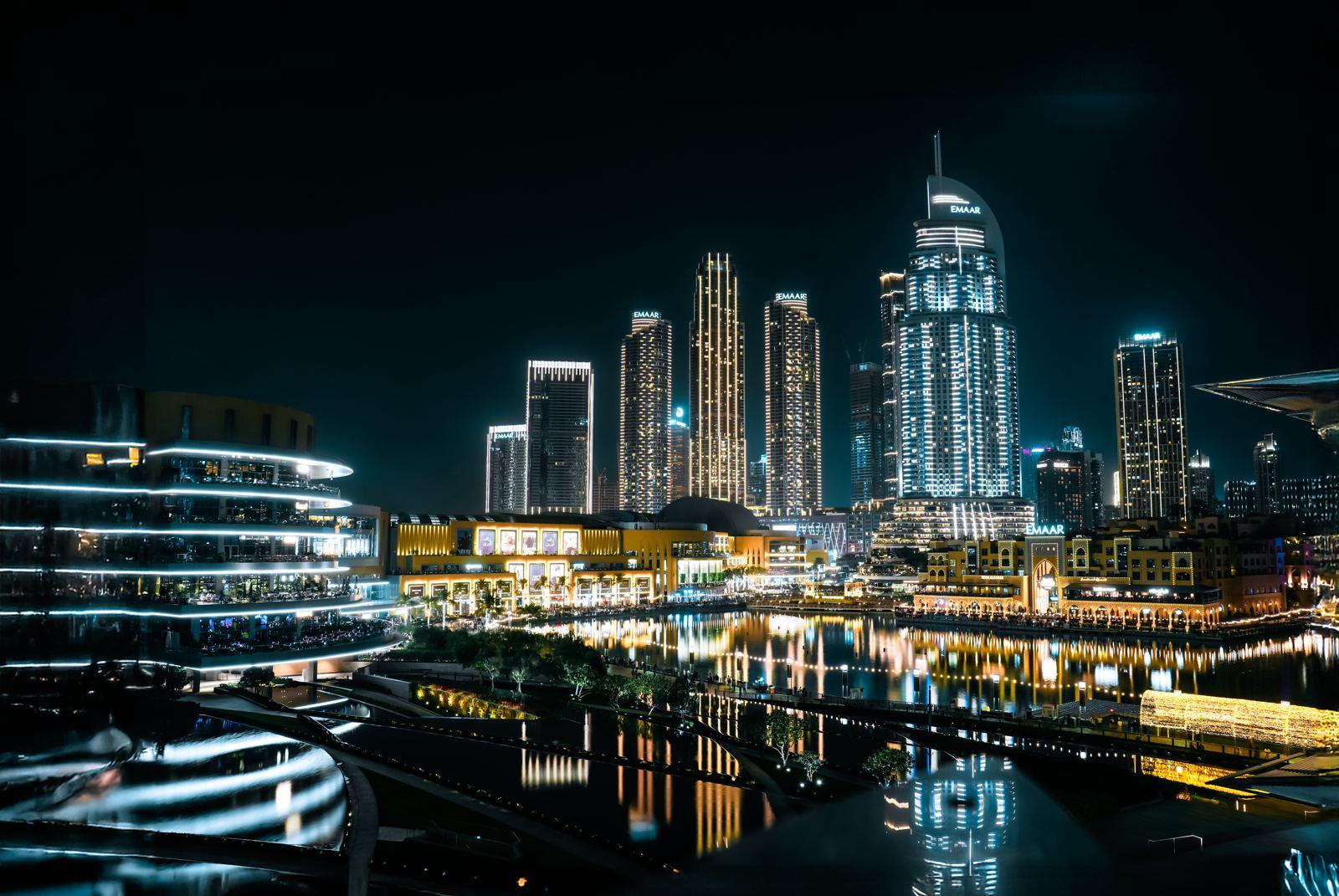 Dubai Marina towers lit at night above the water
