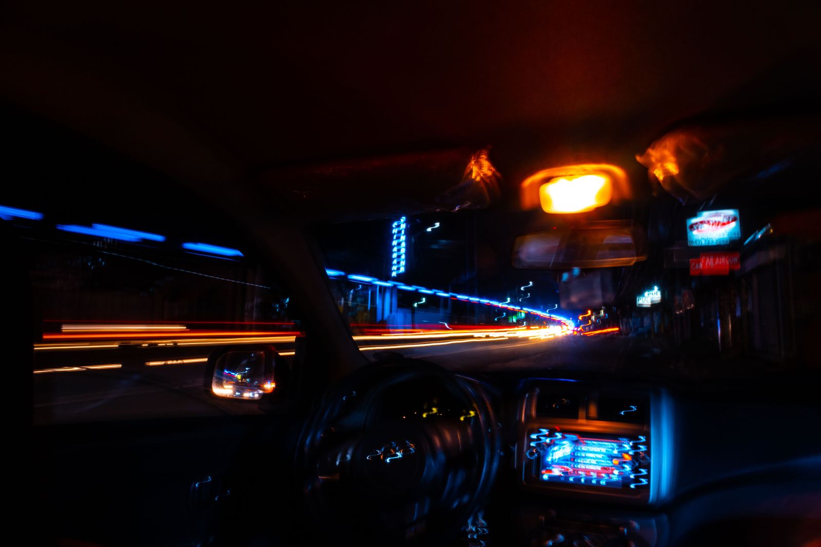 Light trails of a city at night seen from inside a car
