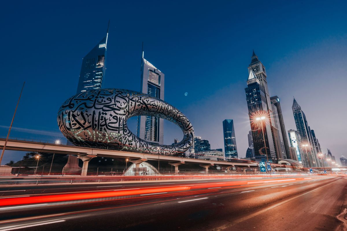 Evening light trails on Sheikh Zayed Road passing the Museum of the Future, Dubai