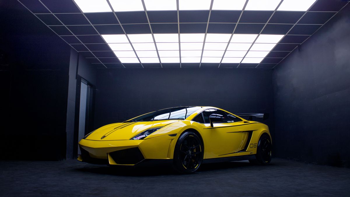 A yellow Lamborghini parked in a clean, brightly lit private garage