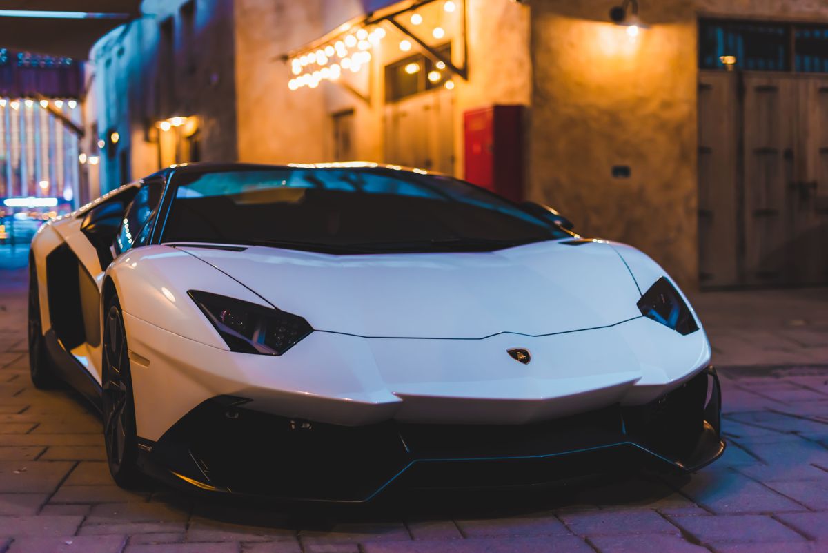 White Lamborghini Aventador parked at night