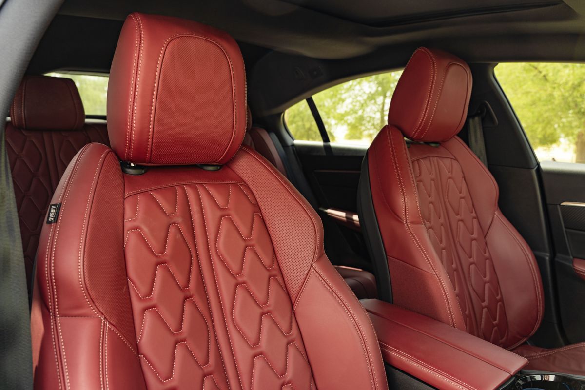 Hand-stitched red leather seats inside a luxury car