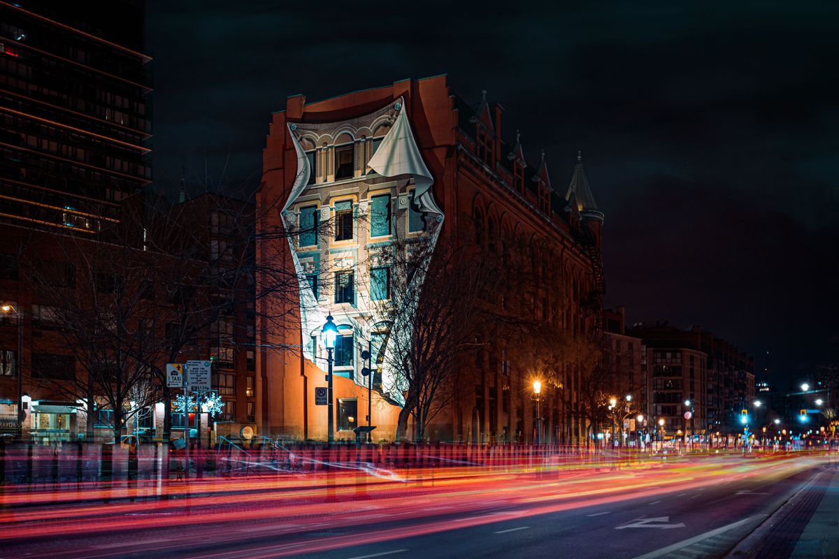 Toronto's Gooderham (Flatiron) Building lit at night with light trails on Front Street