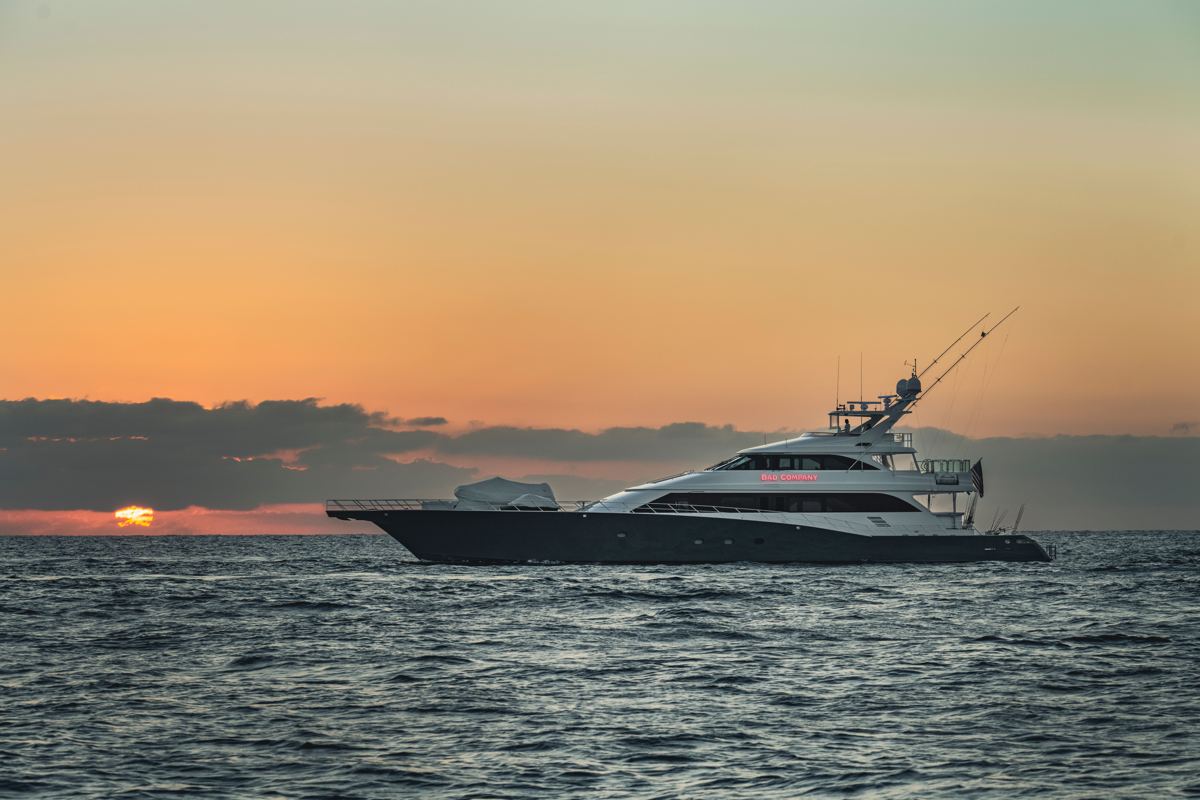 A motor yacht cruising at sunset